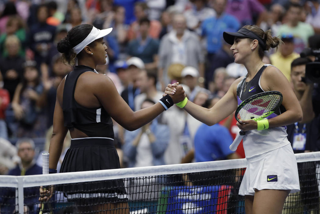 Belinda Bencic, of Switzerland, right, shakes hands after defeating Naomi Osaka, of Japan, 7-5, ...