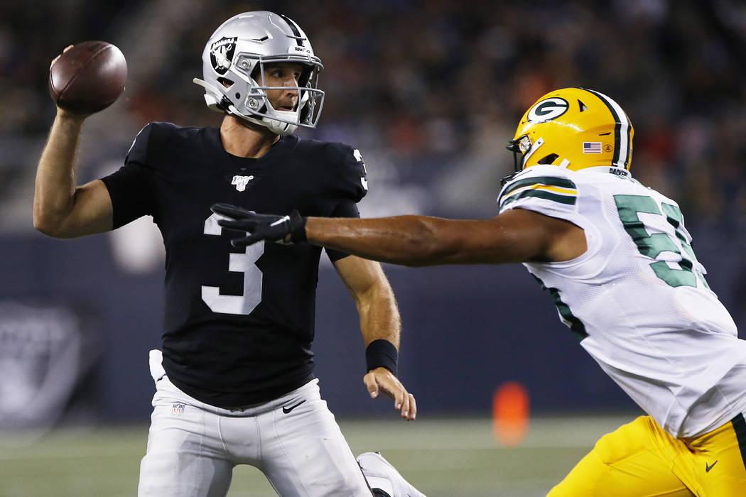 Oakland Raiders quarterback Nathan Peterman (3) throws as Green Bay Packers' Markus Jones (59) ...