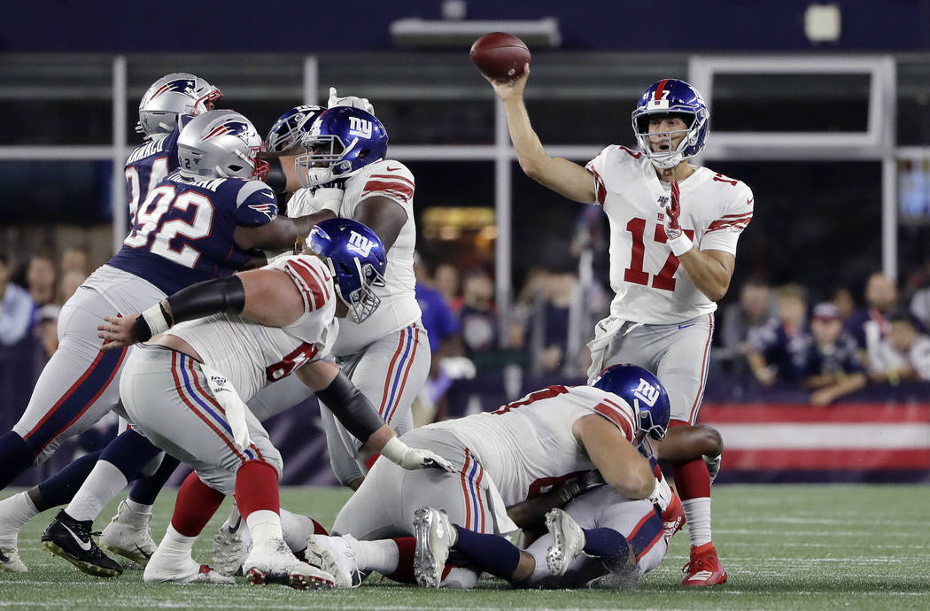 New York Giants quarterback Kyle Lauletta (17) passes under pressure from New England Patriots ...