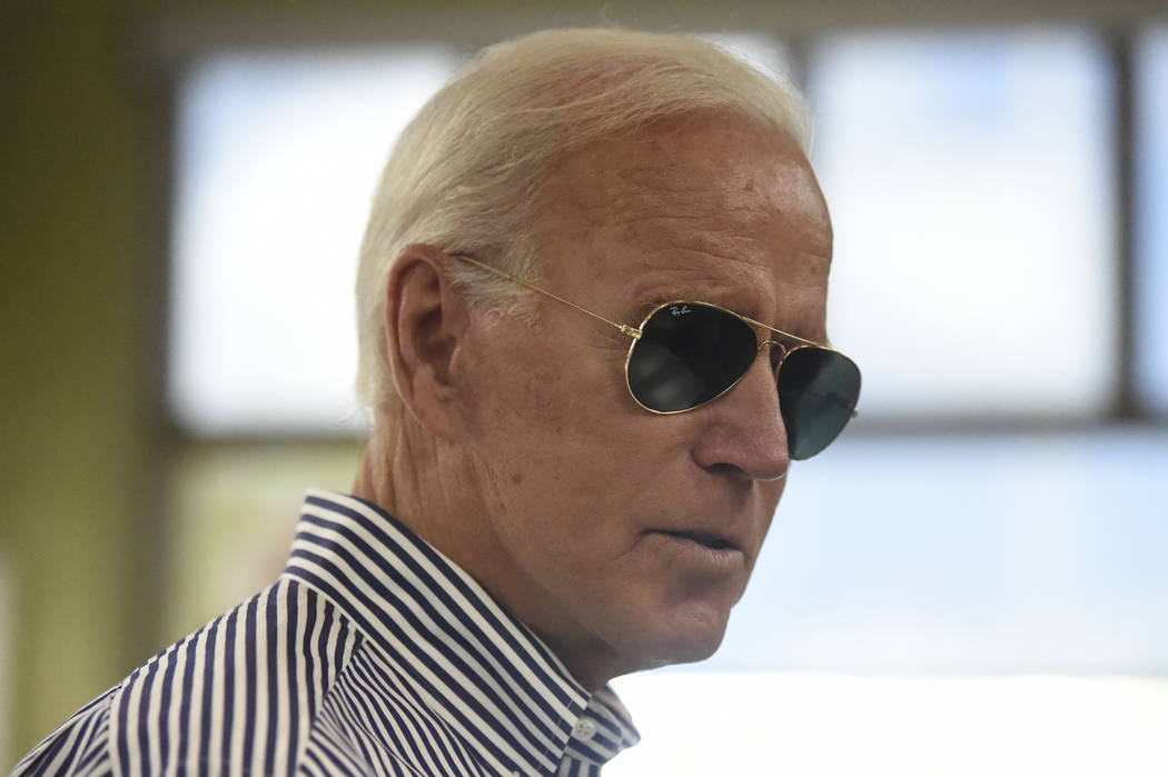 Democratic presidential candidate former Vice President Joe Biden pays for his order at a Krisp ...