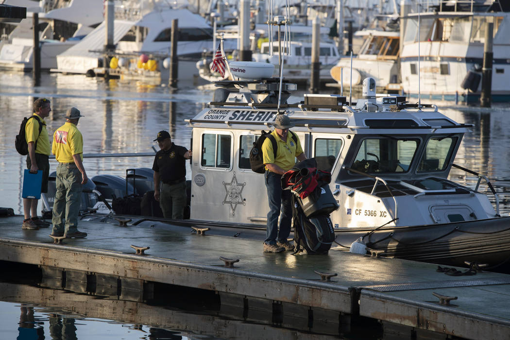 Divers with the San Luis Obispo County Sheriff's Dive Team prepare to search for missing people ...