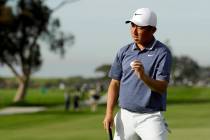 Doug Ghim waves on the 18th green after the first round of the Farmers Insurance Open golf tour ...