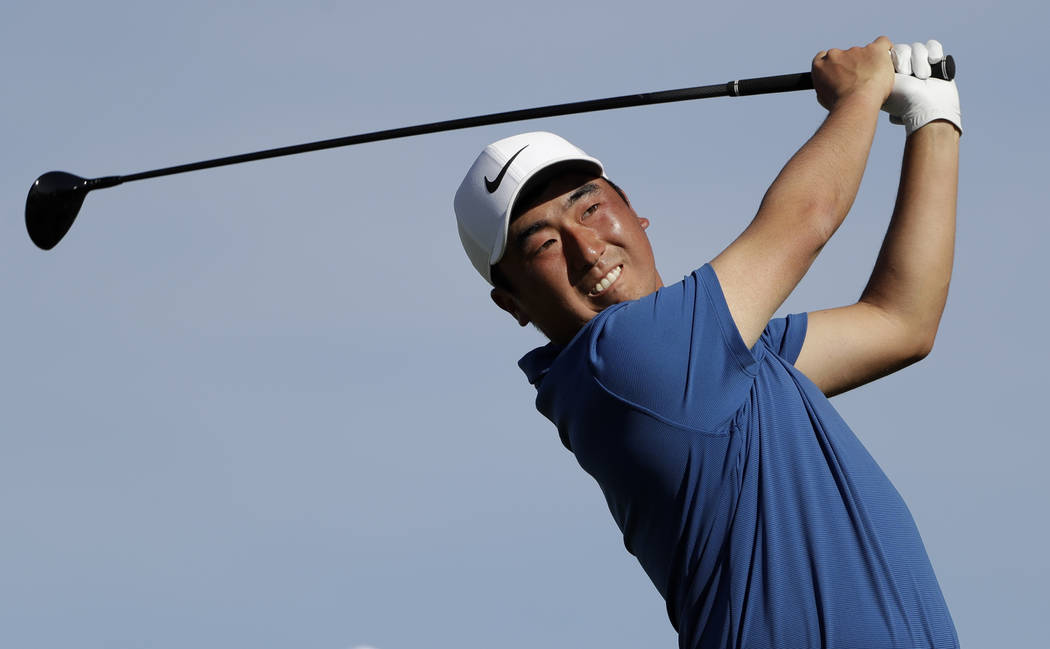 Doug Ghim watches his tee shot on the second hole of the South Course at Torrey Pines Golf Cour ...