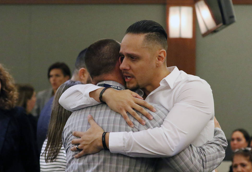 Alberto Sarabia, right, father of shooting victim 11-year-old Angelina Erives, hugs Bryan Booke ...