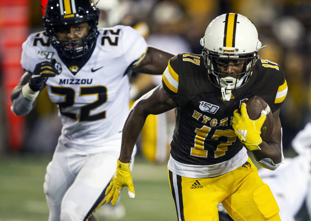 Wyoming receiver Raghib Ismail Jr. (17) runs for yardage as Missouri's Aubrey Miller (22) pursu ...