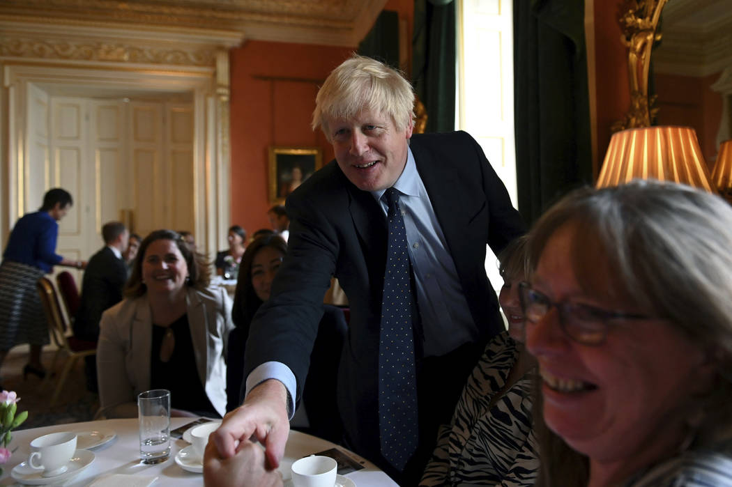 Britain's Prime Minister Boris Johnson speaks with NHS workers during a reception at 10 Downing ...