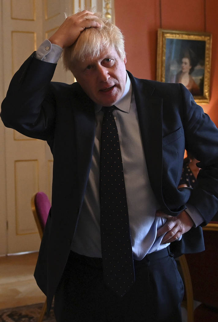 Britain's Prime Minister Boris Johnson speaks with NHS workers during a reception at 10 Downing ...