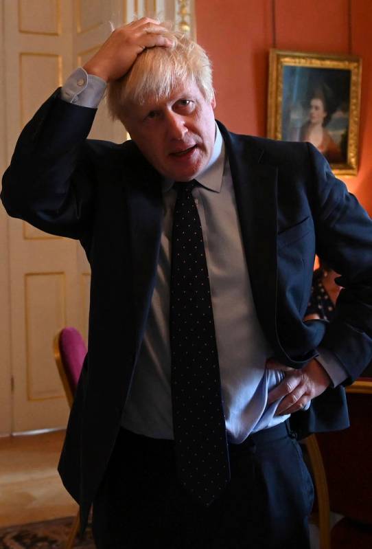 Britain's Prime Minister Boris Johnson speaks with NHS workers during a reception at 10 Downing ...