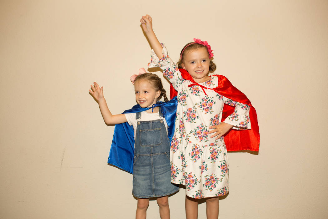 At right, Superhero Ambassador Navy Bishop, 6, and her younger sister Riley wear their superher ...