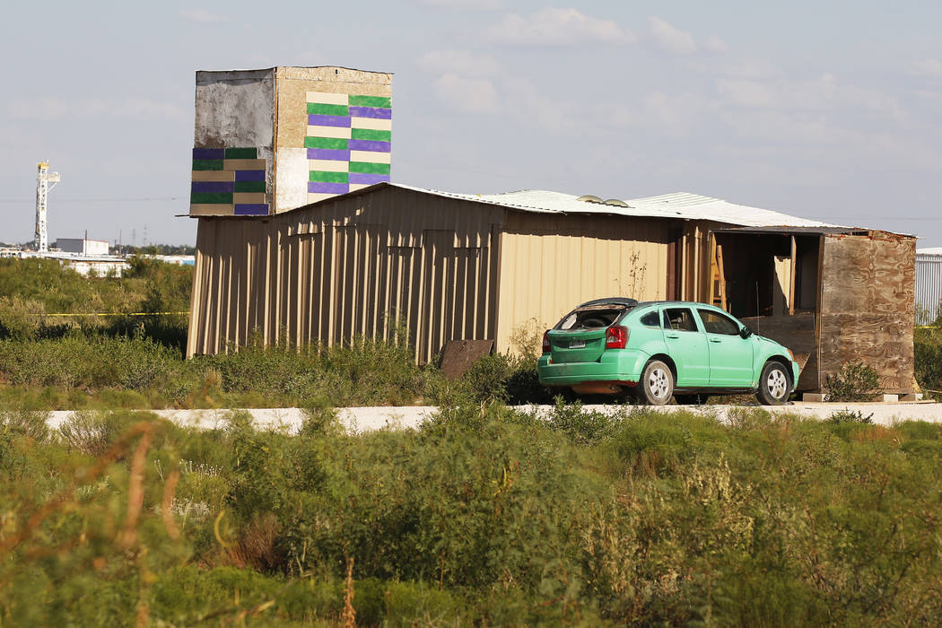 A drilling rig can be seen behind the home of Seth Ator, the alleged gunman in a West Texas ram ...