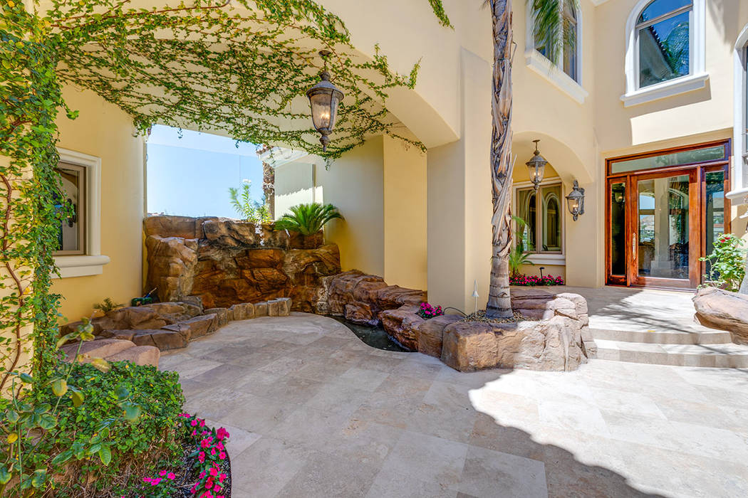 The entrance to the home features a courtyard with a waterfall. (Ivan Sher Group)