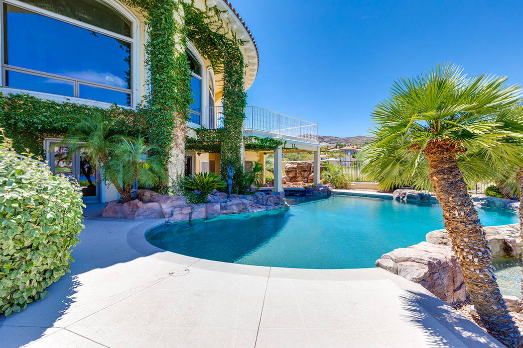 The pool curves around the backyard patio. (Ivan Sher Group)