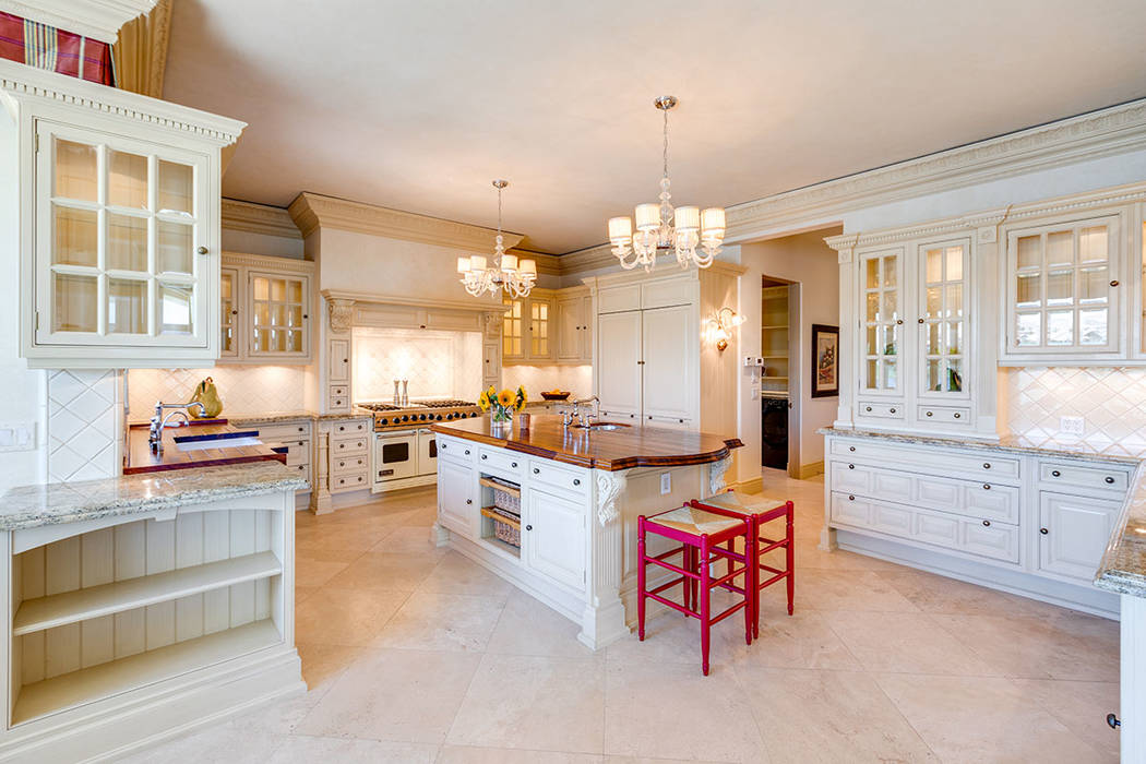 The kitchen’s Christians custom cabinetry lend to a traditional country estate aesthetic. (Iv ...