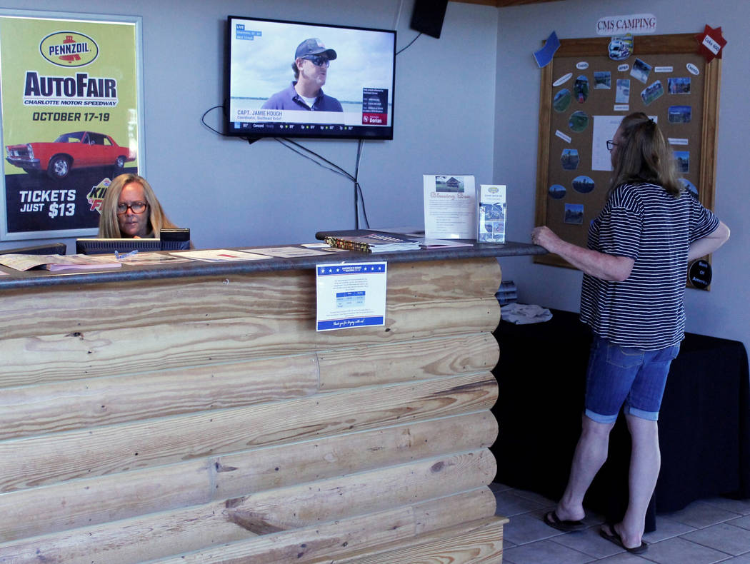 Sharon Entrekin, right, of Southport, N,C., looks at television coverage of Hurricane Dorian as ...