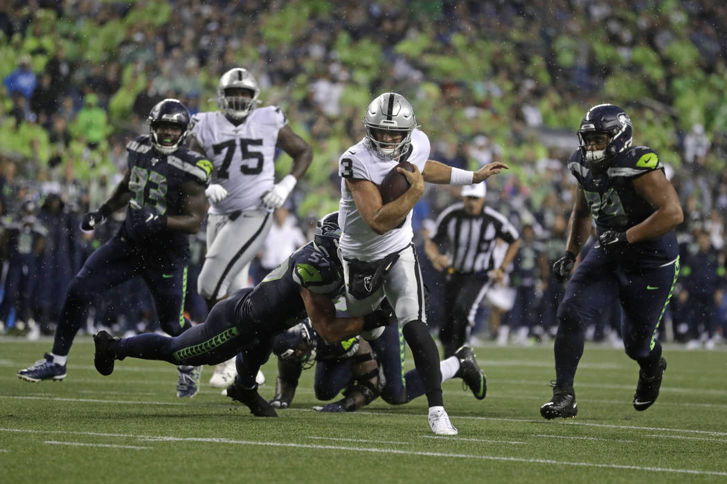 Oakland Raiders quarterback Nathan Peterman (3) scrambles, but Seattle Seahawks linebacker Cody ...