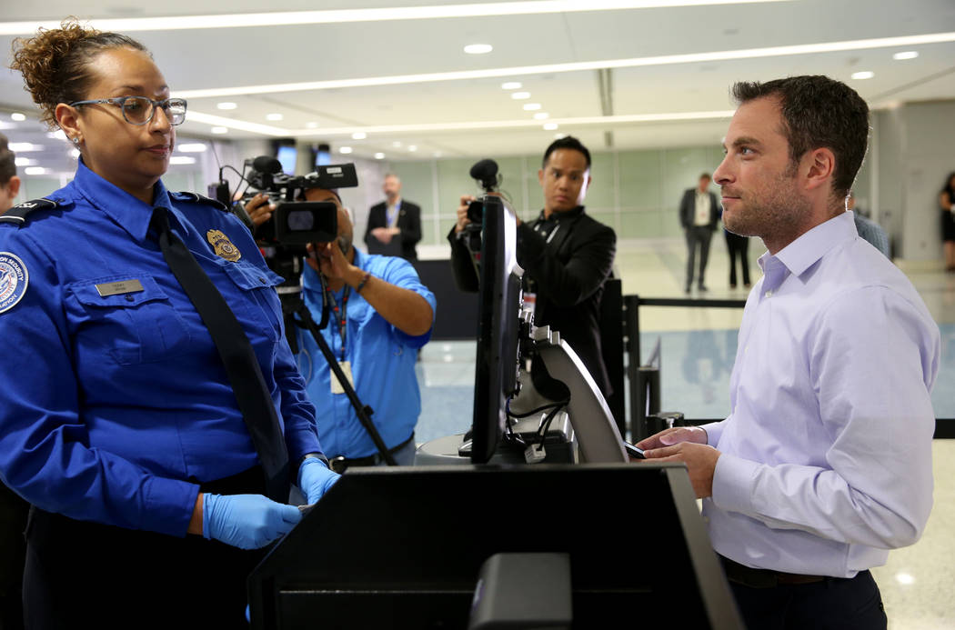 Transportation Security Officer Terry demonstrates Credential Authentication Technology with To ...