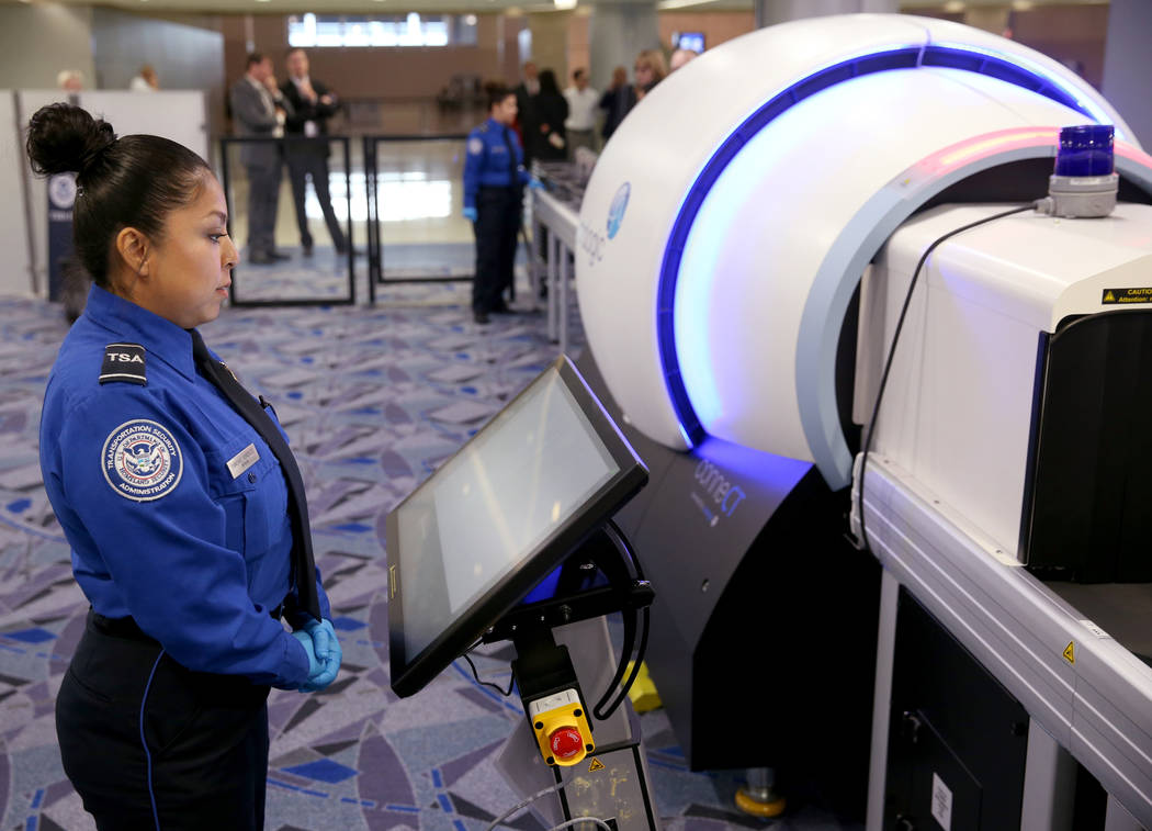 Transportation Security Officer Sanchez Gonzalez demonstrates a 3D scanner during an announceme ...