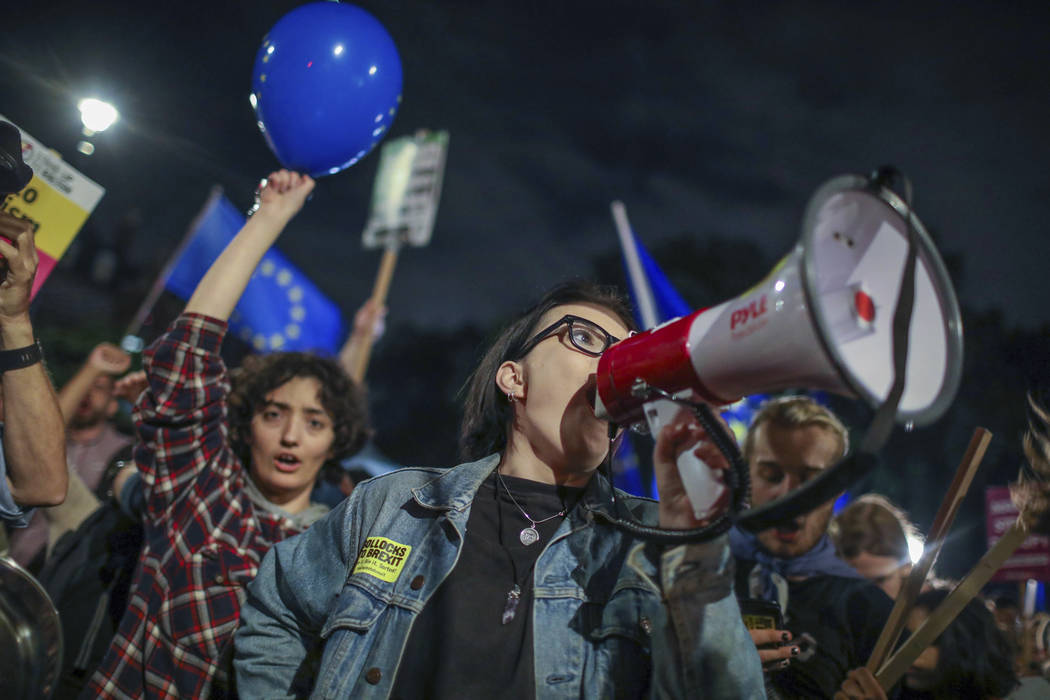 Protesters outside the House of Commons, London, Tuesday, Sept. 3, 2019. British Prime Minister ...