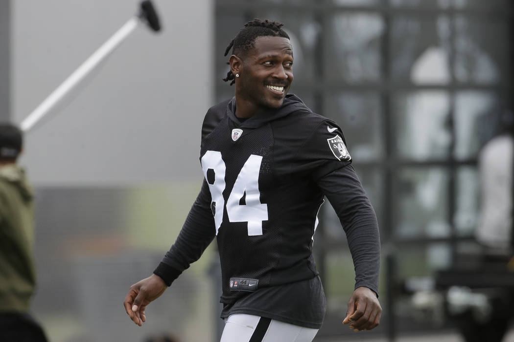 Oakland Raiders' Antonio Brown smiles before stretching during NFL football practice in Alameda ...