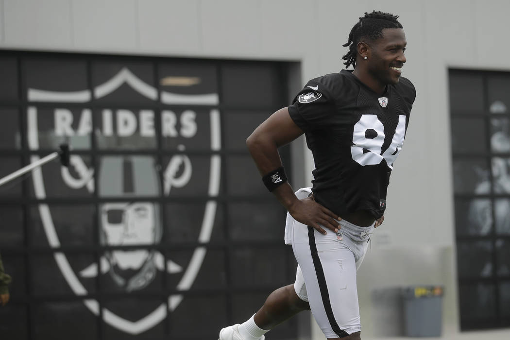 Oakland Raiders' Antonio Brown smiles before stretching during NFL football practice in Alameda ...