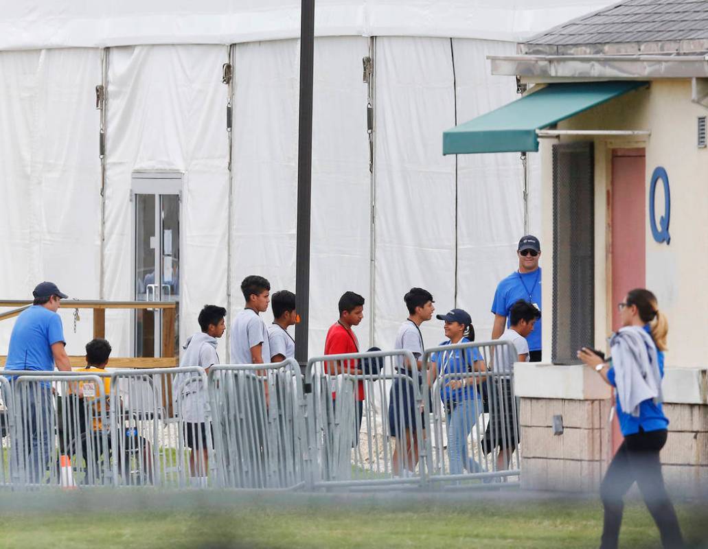 FILE - In this June 20, 2018 photo, immigrant children walk in a line outside the Homestead Tem ...