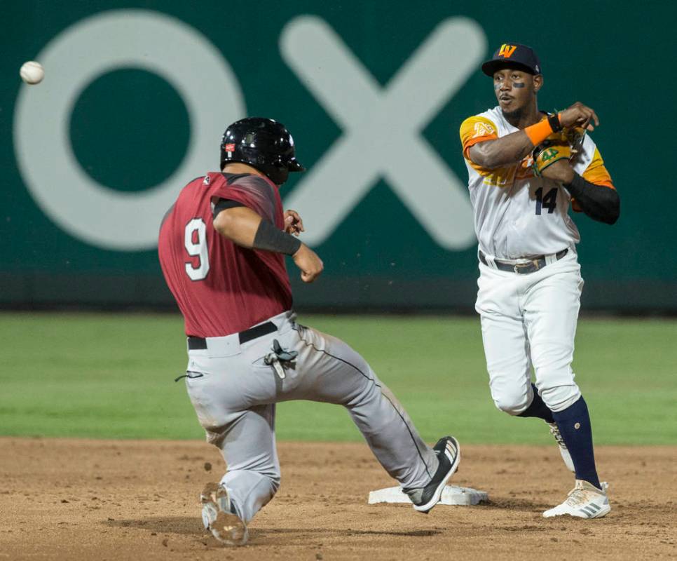 Las Vegas Aviators shortstop Jorge Mateo (14) turns a double play past Sacramento River Cats sh ...