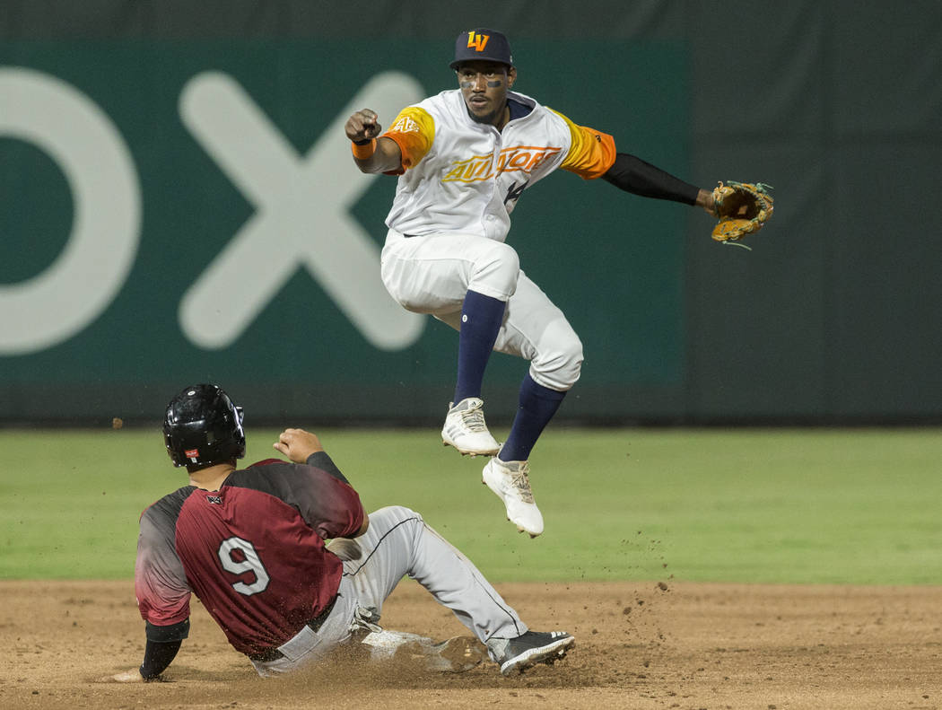 Las Vegas Aviators shortstop Jorge Mateo (14) leaps over Sacramento River Cats shortstop Crist ...