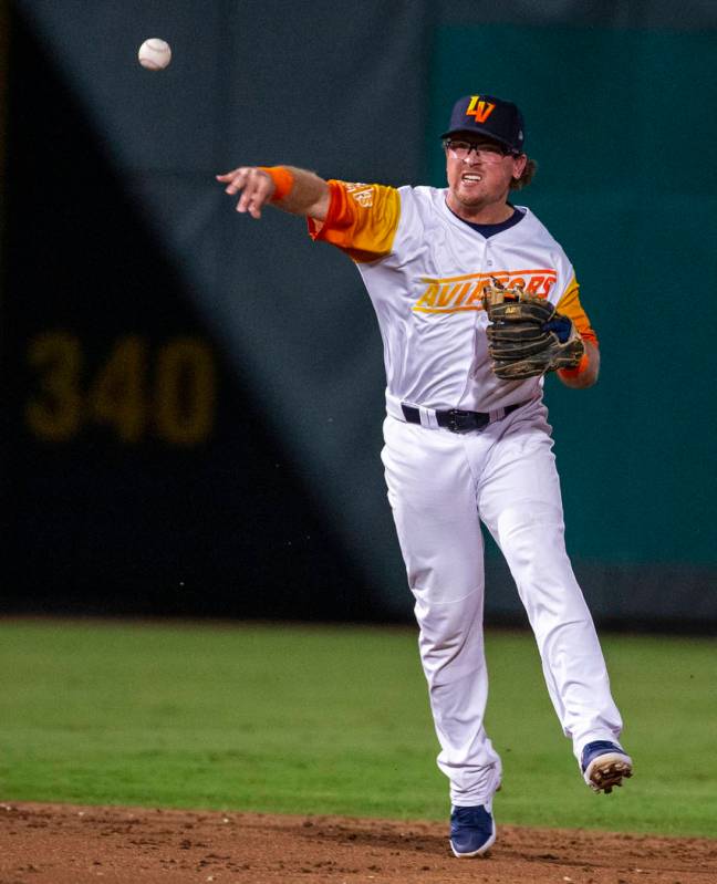 Las Vegas Aviators shortstop Trace Loehr (7) tosses the ball to first base for an out versus th ...