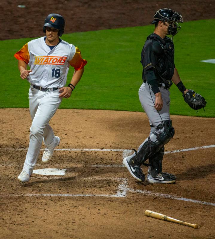 Las Vegas Aviators catcher Dustin Garneau (18) scores late versus the Sacramento River Cats dur ...