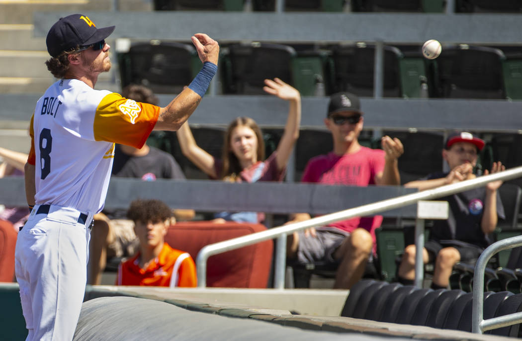 Las Vegas Aviators right fielder Skye Bolt (8) tosses a foul ball to a fan in the fourth inning ...