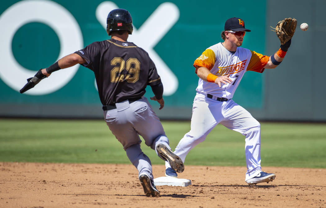 Las Vegas Aviators second baseman Trace Loehr (7, right) readies to make the out in the fourth ...