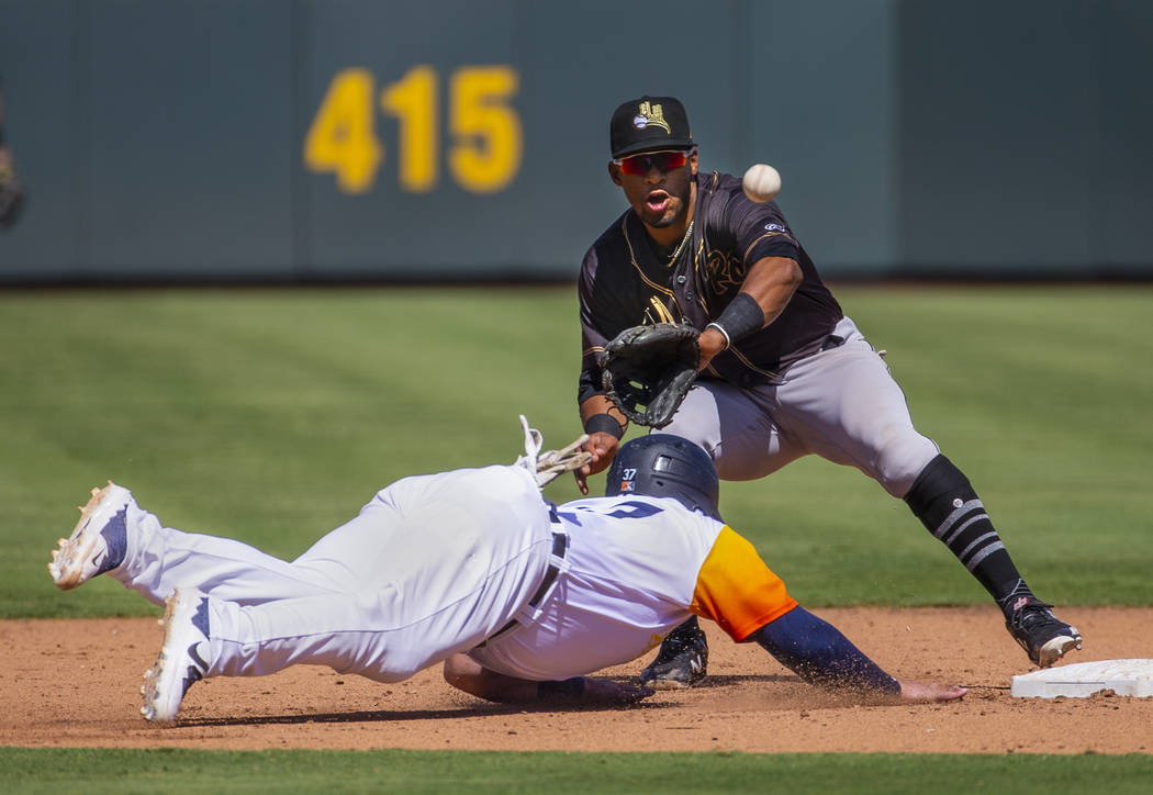 Las Vegas Aviators catcher Cameron Rupp (37, left) dives safely back to second just under a thr ...