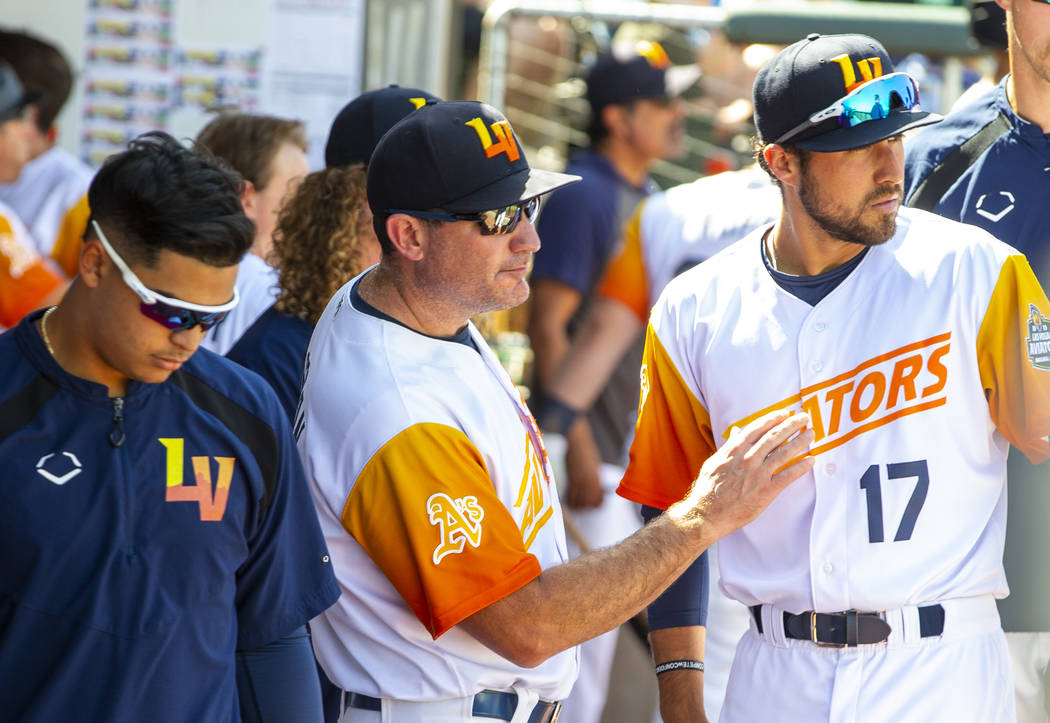 Las Vegas Aviators manager Fran Riordan (39, center) confers with first baseman Alfonso Rivas ( ...