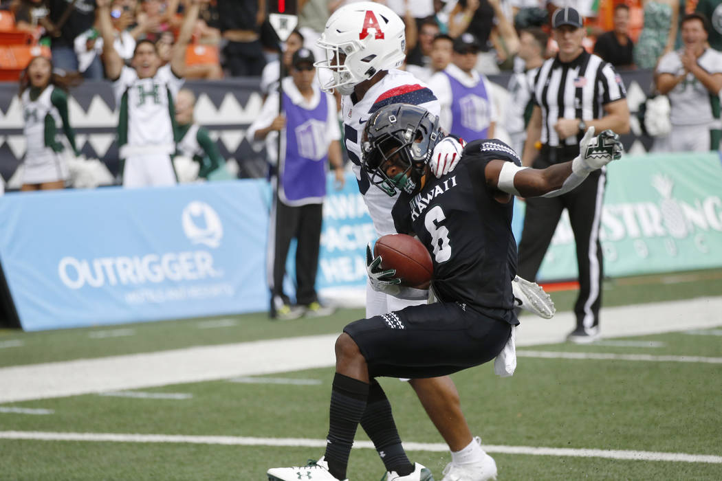 Arizona safety Scottie Young Jr. (6) can't stop Hawaii wide receiver Cedric Byrd II (6) from ma ...