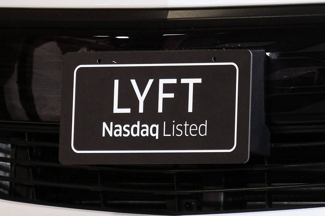 FILE- In this March 29, 2019, file photo a sign for Lyft is displayed on a car in Los Angeles. ...