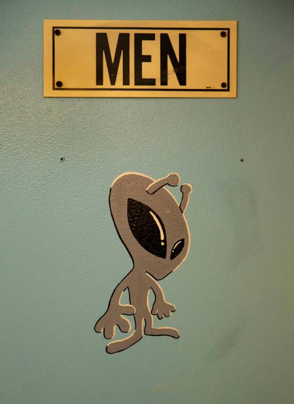 An alien sticker is on the men's bathroom door in the restaurant at the Little A'Le'Inn which i ...