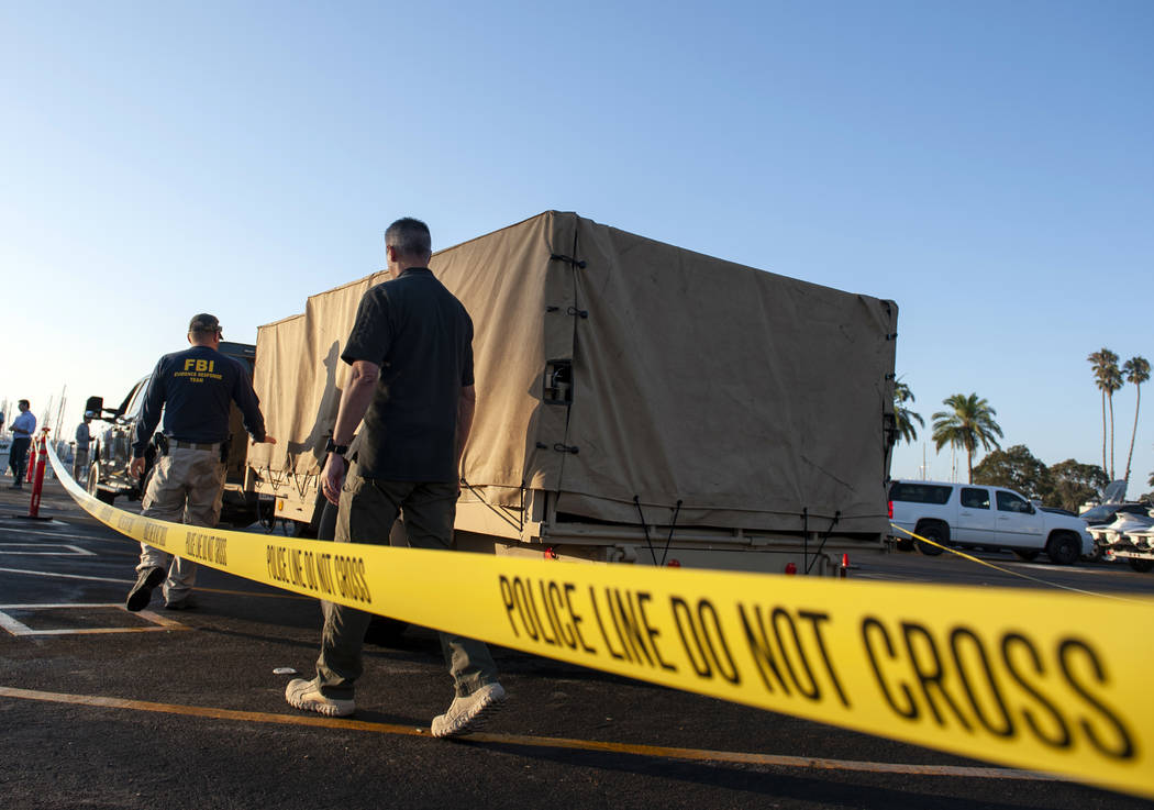 FBI investigators unload equipment to begin examining evidence obtained from the wreckage of th ...