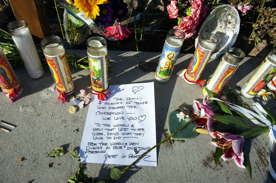 A handwritten message from members of the diving community is displayed at a memorial for the v ...