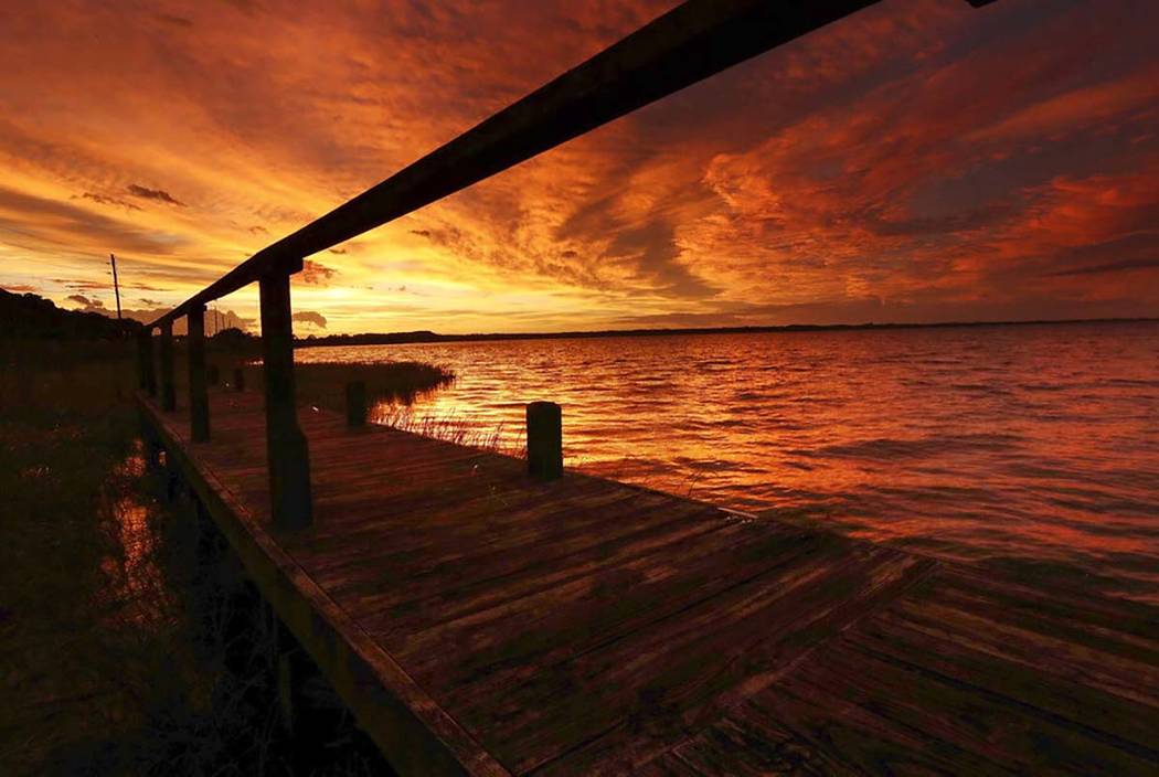 The sun sets over Lake Eustis in Tavares, Fla., on Wednesday, Sept. 4, 2019. By Wednesday, Hurr ...