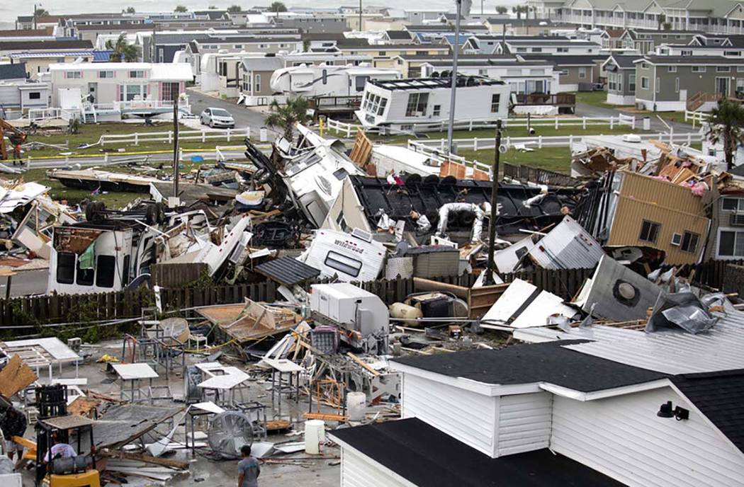 Mobile homes are upended and debris is strewn about at the Holiday Trav-l Park, Thursday, Sept. ...