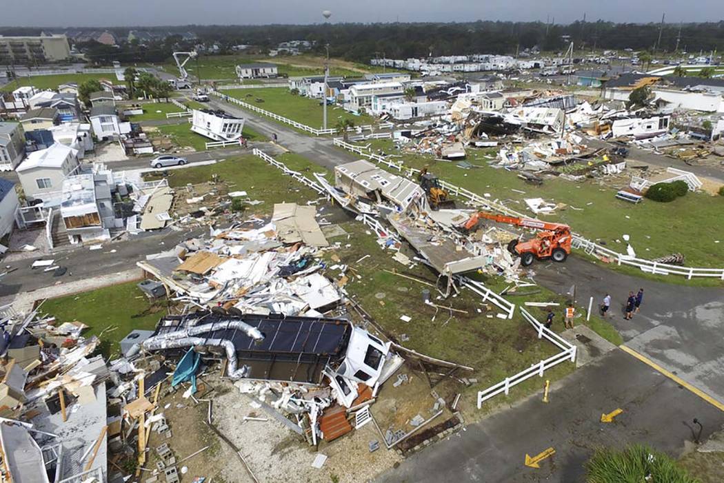 CORRECTS YEAR TO 2019-Emerald Isle town employees work to clear the road after a tornado hit Em ...