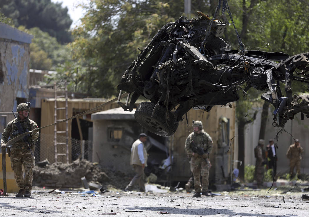 Resolute Support (RS) forces remove a damaged vehicle after a car bomb explosion in Kabul, Afgh ...