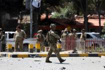 Resolute Support (RS) forces and Afghan security personnel inspect the site of a car bomb explo ...