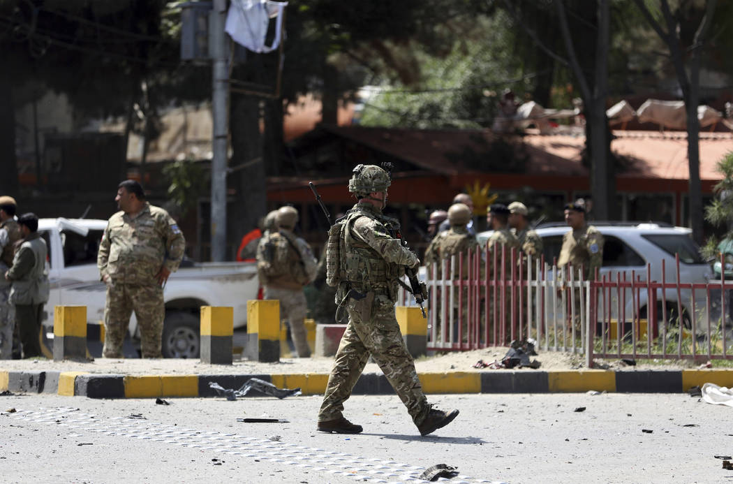 Resolute Support (RS) forces and Afghan security personnel inspect the site of a car bomb explo ...