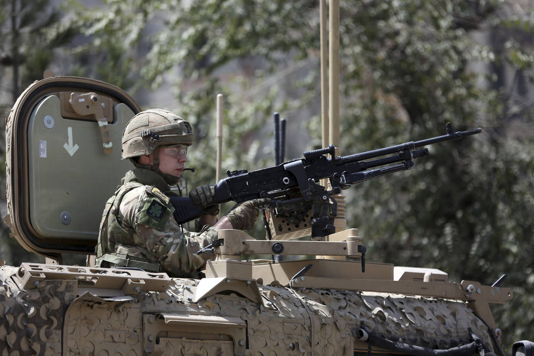 Resolute Support (RS) forces guard at the site of a car bomb explosion in Kabul, Afghanistan, T ...