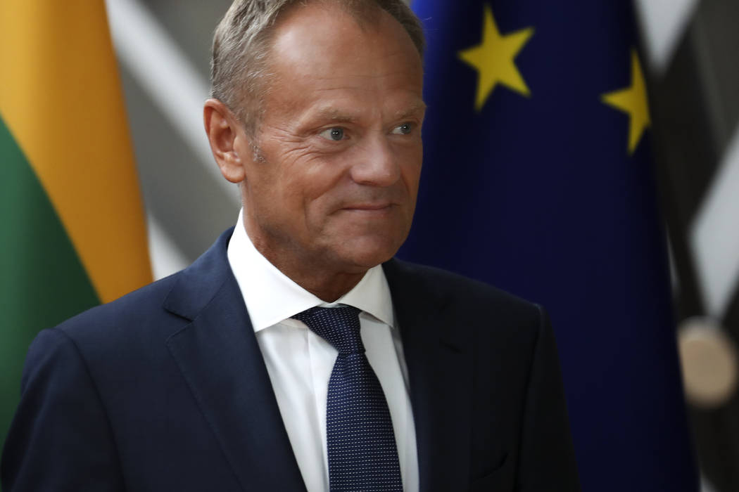 European Council President Donald Tusk walks by the EU flag prior to a meeting with Lithuania's ...