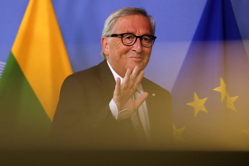 European Commission President Jean-Claude Juncker waves to the media before before his meeting ...