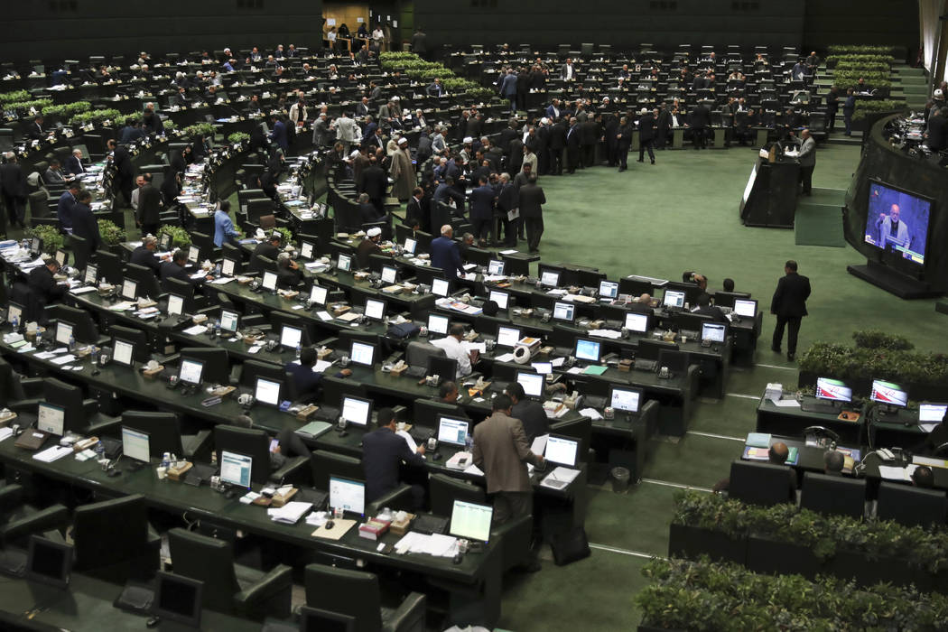 Iranian lawmakers attend a session of the parliament to debate President Hassan Rouhani's propo ...