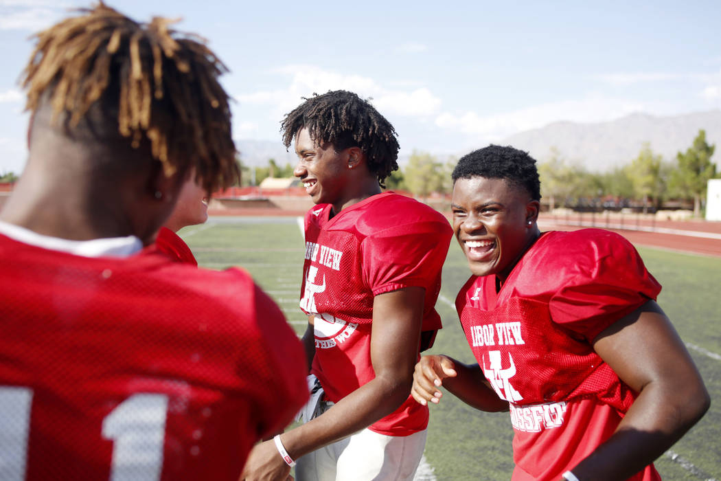 Arbor View's running backs Daniel Mitchell (24), center, and Darius Williams (30), during prac ...