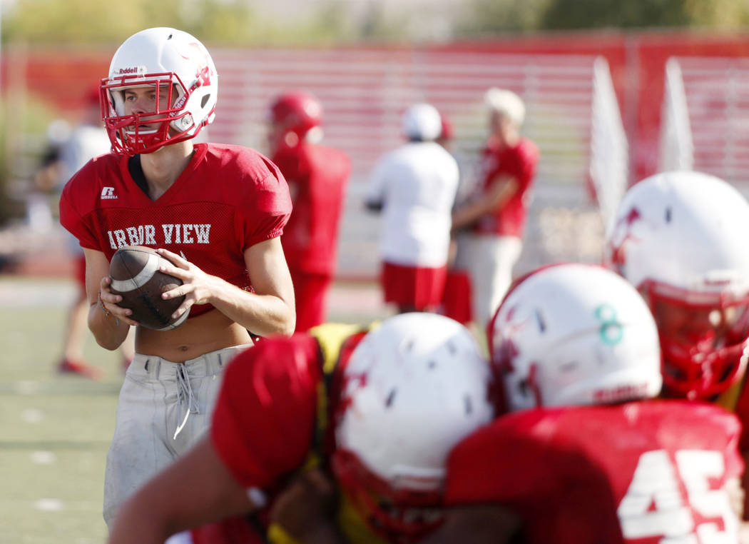 Arbor View's varsity quarterback Kyle Holmes (17), runs drills during practice at Arbor View Hi ...